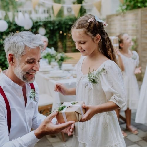 mature father receiving gift from daughter at wedding